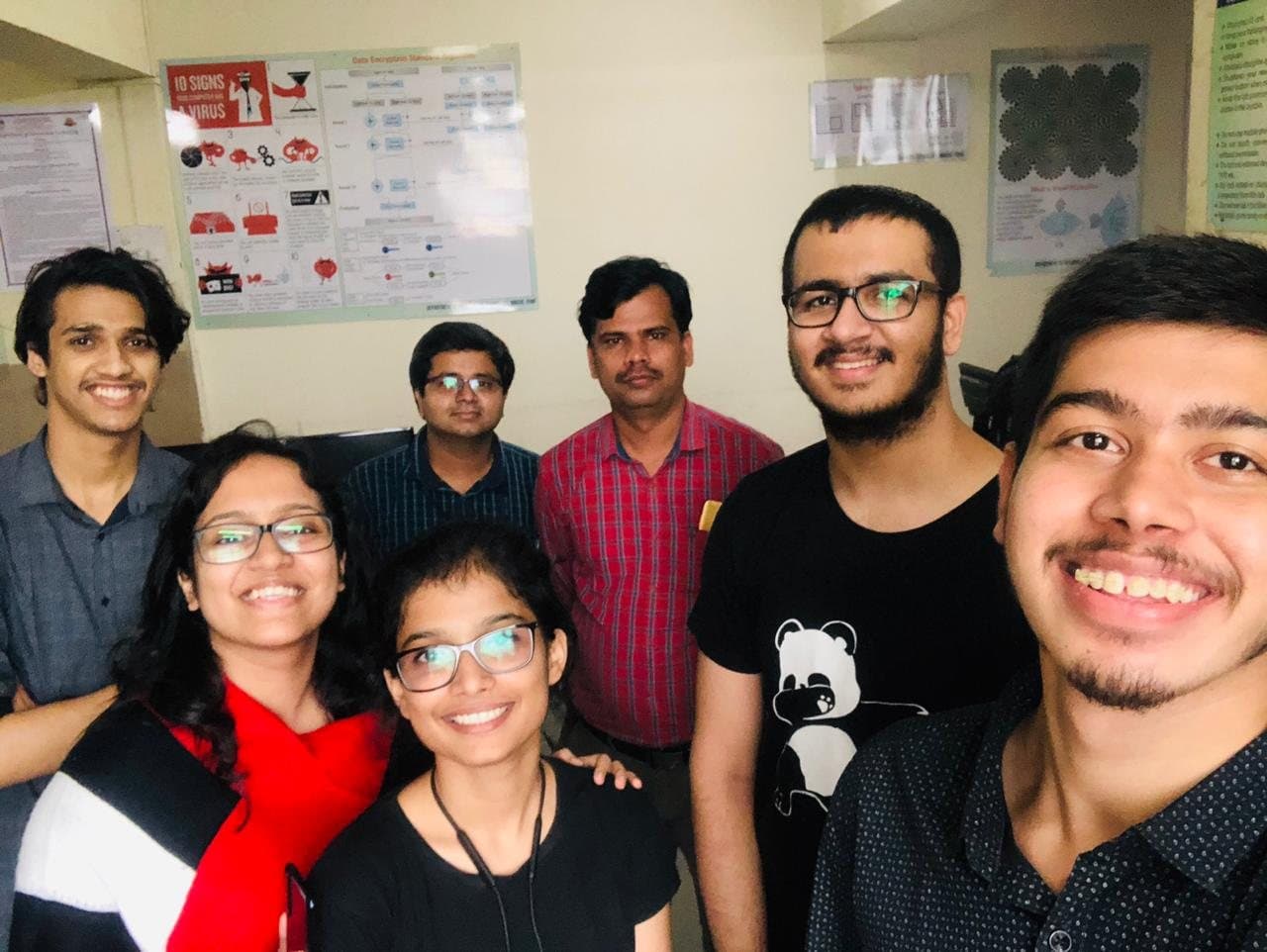 Team Psycool and their mentor smiling in a selfie in the college lab