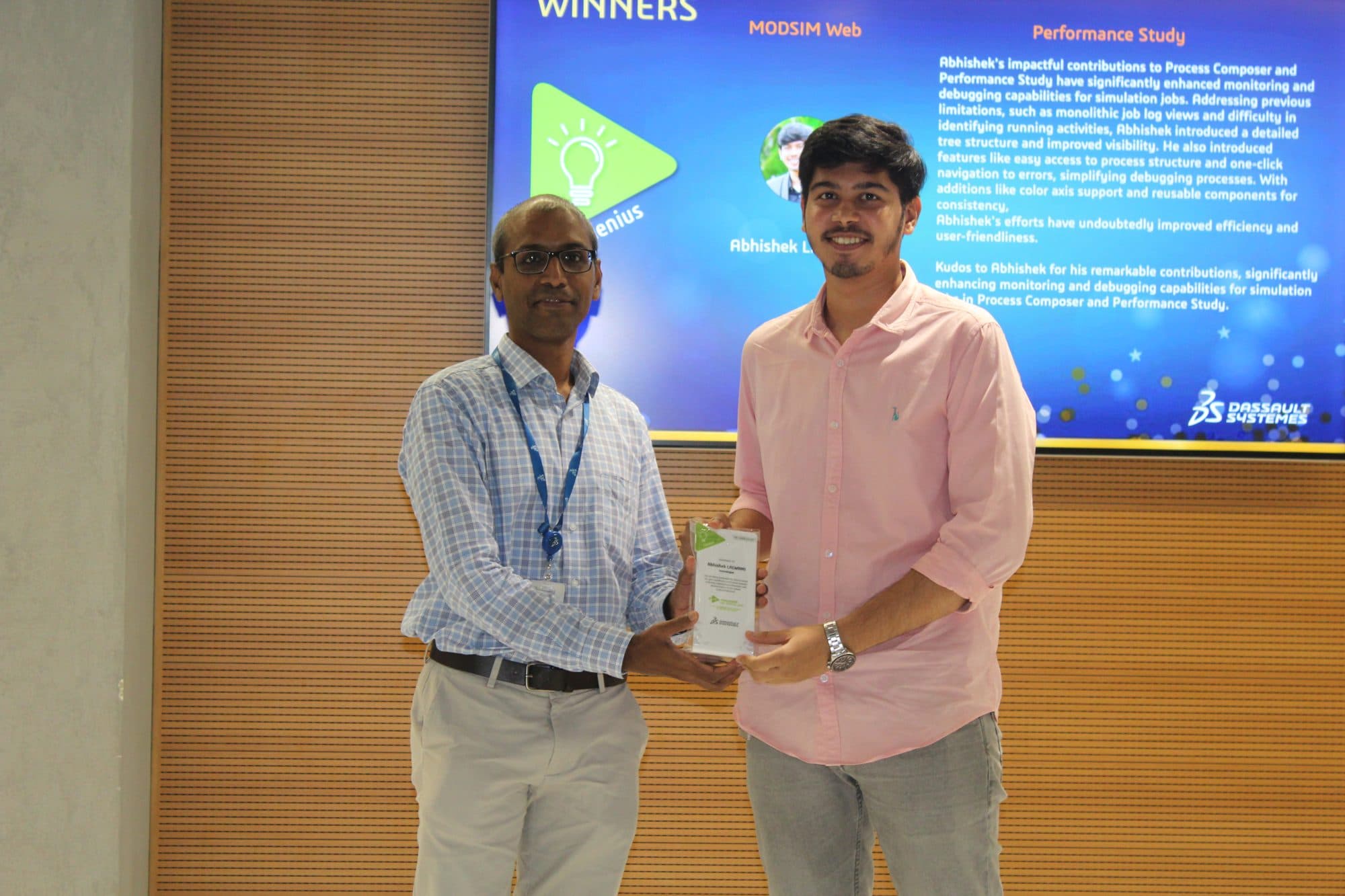 Receiving the Genius Award in front of a screen describing the contribution