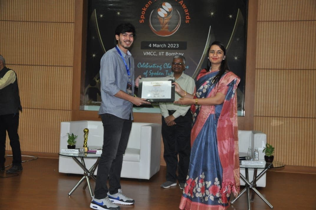 Receiving a framed certificate on stage at the Spoken Tutorial awards, IIT Bombay